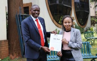 Optiven Group CEO George Waciuri presents Title Deed to client