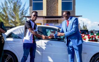 Optiven Group CEO George Waciuri poses with Furahia na Optiven Mercedez CI80 Winner.
